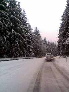 [billede: bil på en vej dækket med sne]